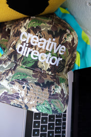Creative Director Camo Trucker Hat